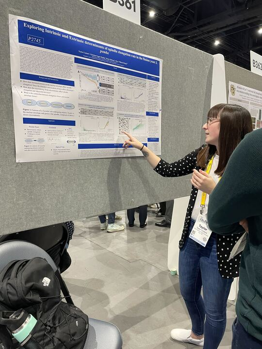 Graduate student Taylor Couture presents her poster